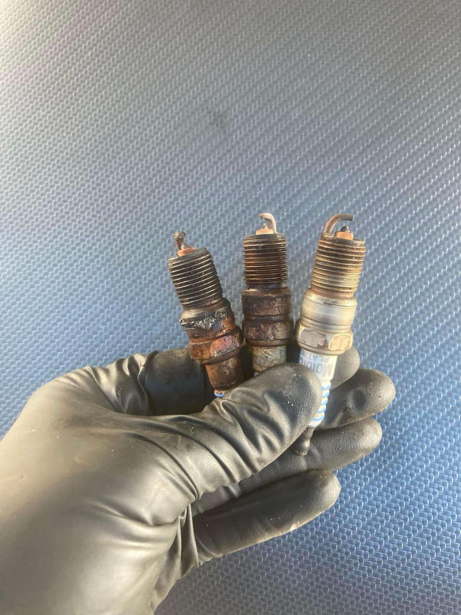 Mechanic performing a tune-up on a car