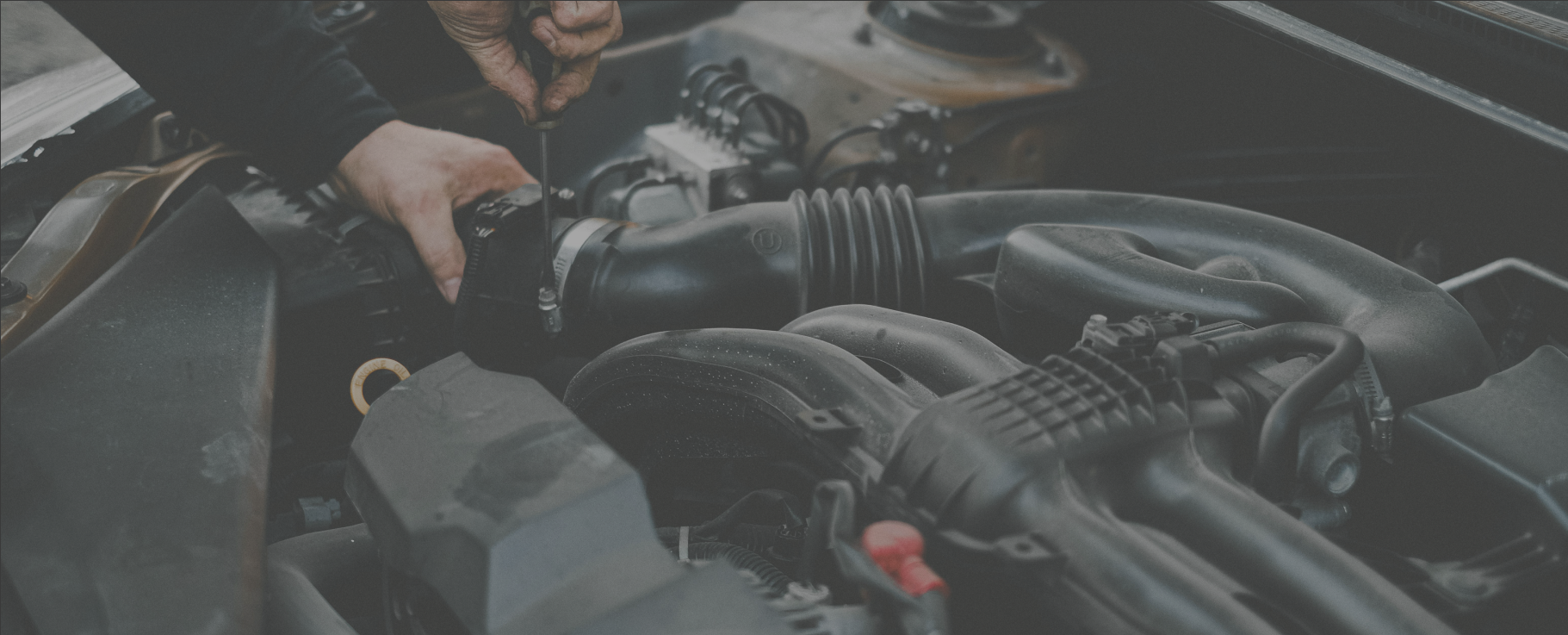 mechanic working on the engine of an automobile